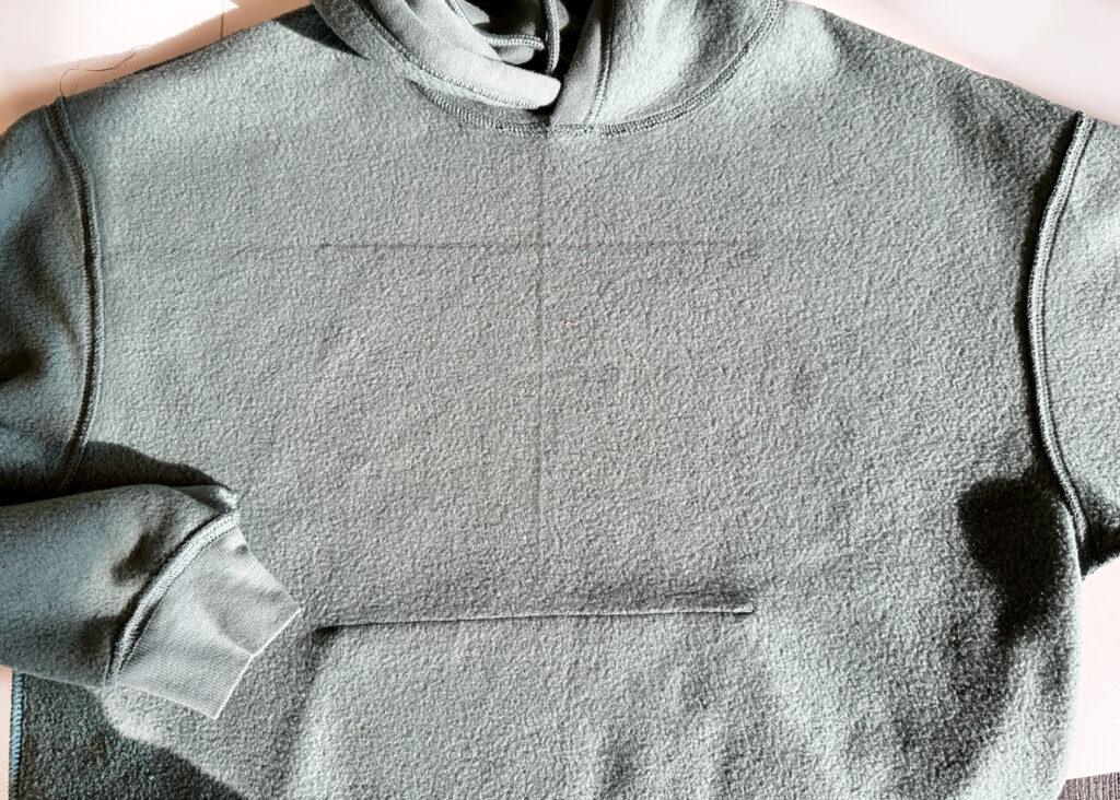 Placement lines drawn on plain hoodie for reverse applique project