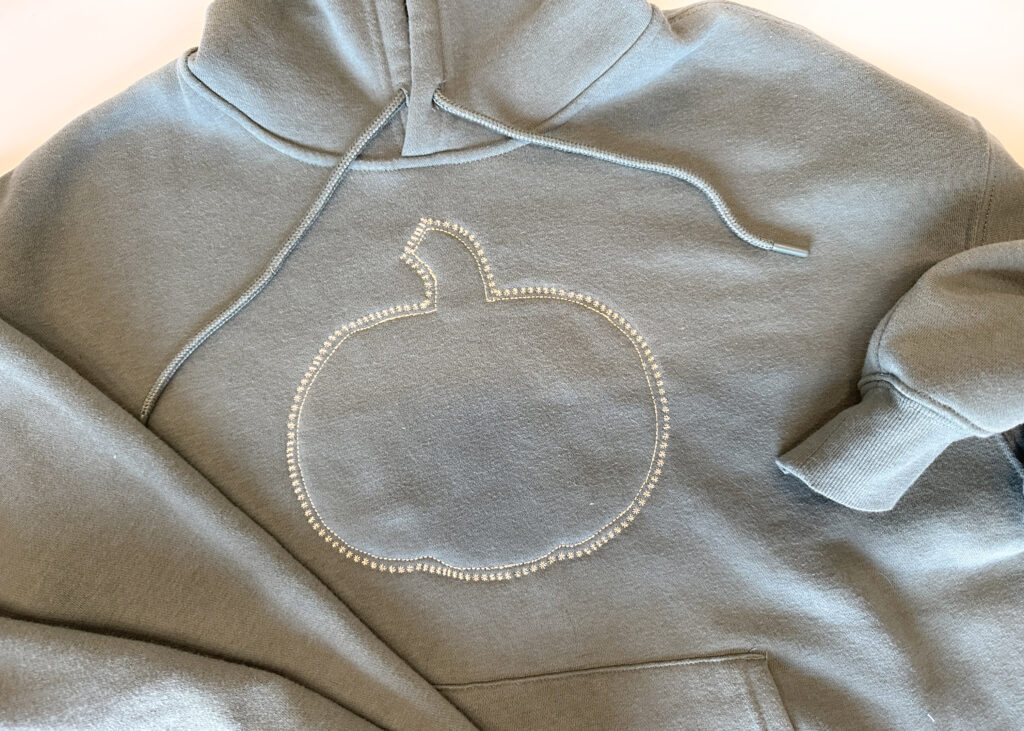 Completed decorative stitching on hoodie for reverse applique project