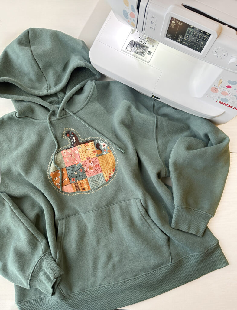 Completed patchwork pumpkin appliqué sweatshirt made with NE210 sewing machine